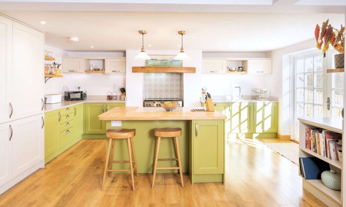 Traditional bespoke kitchen with sage green island, oak worktops and open-plan family layout in Devon